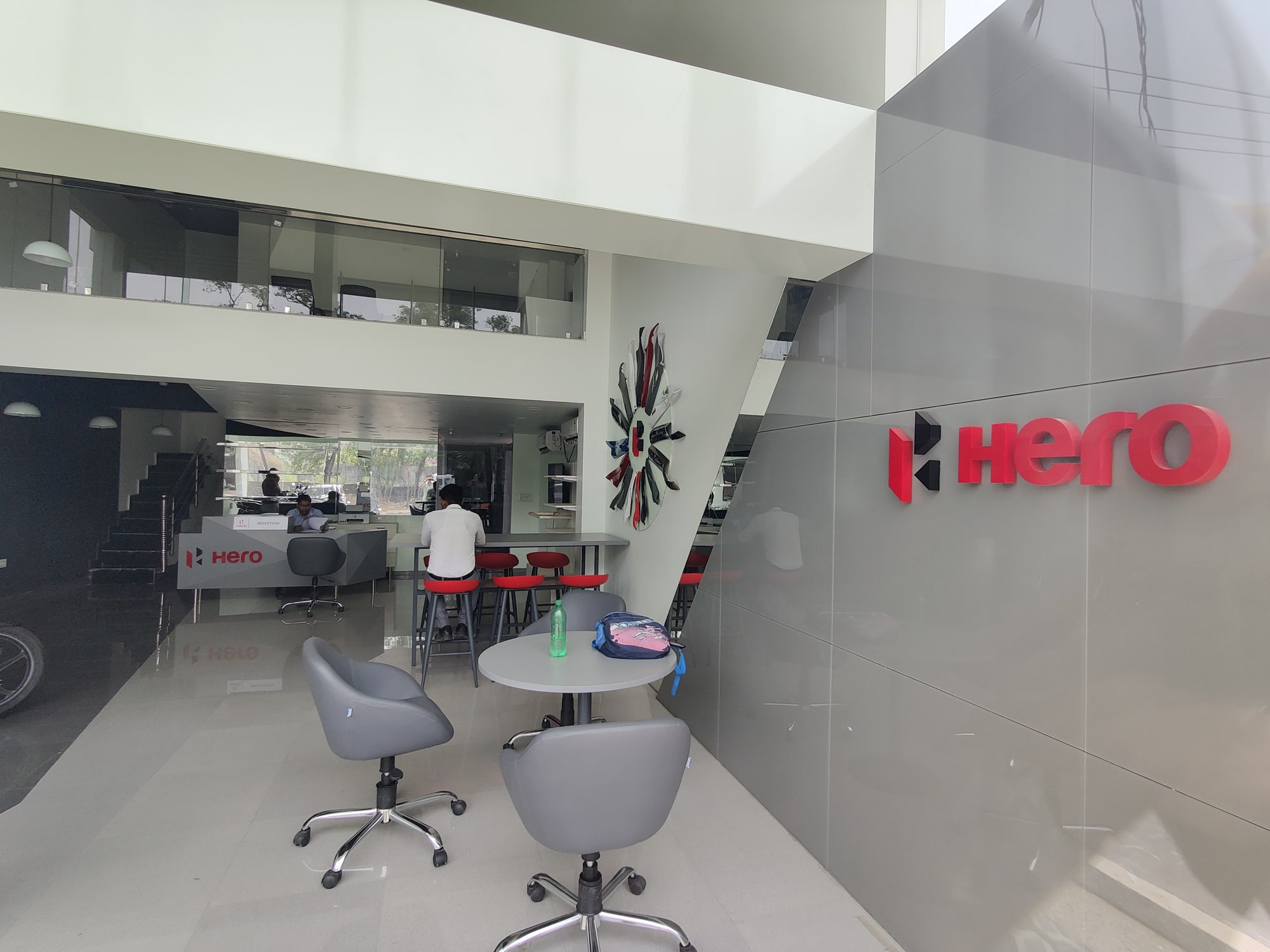 Built Hero showroom interior with motorcycle display, customer discussion tables and a mezzanine overlooking the main space