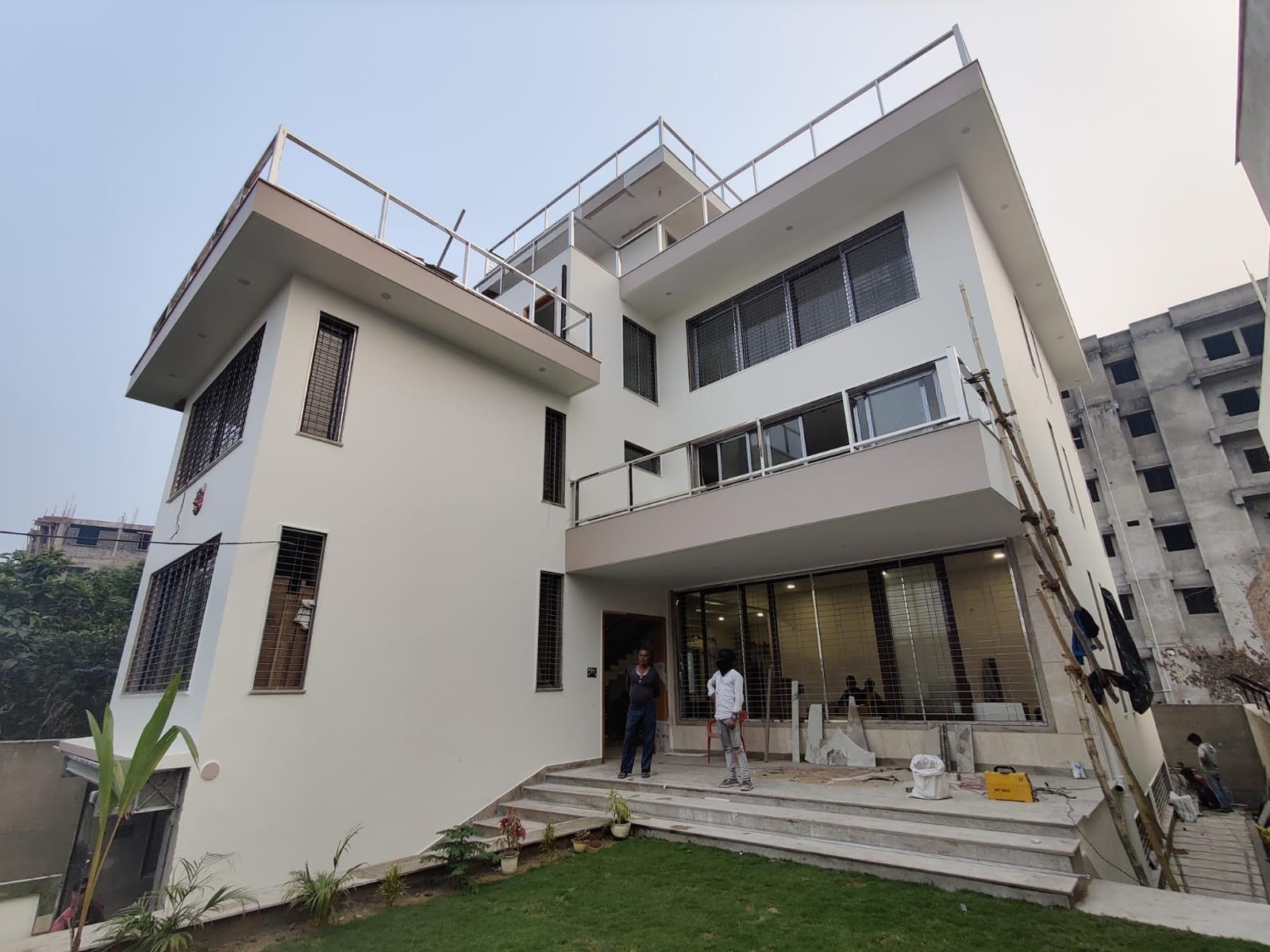 Built Manorath Residence viewed from the garden, with verandah, balconies and terraces